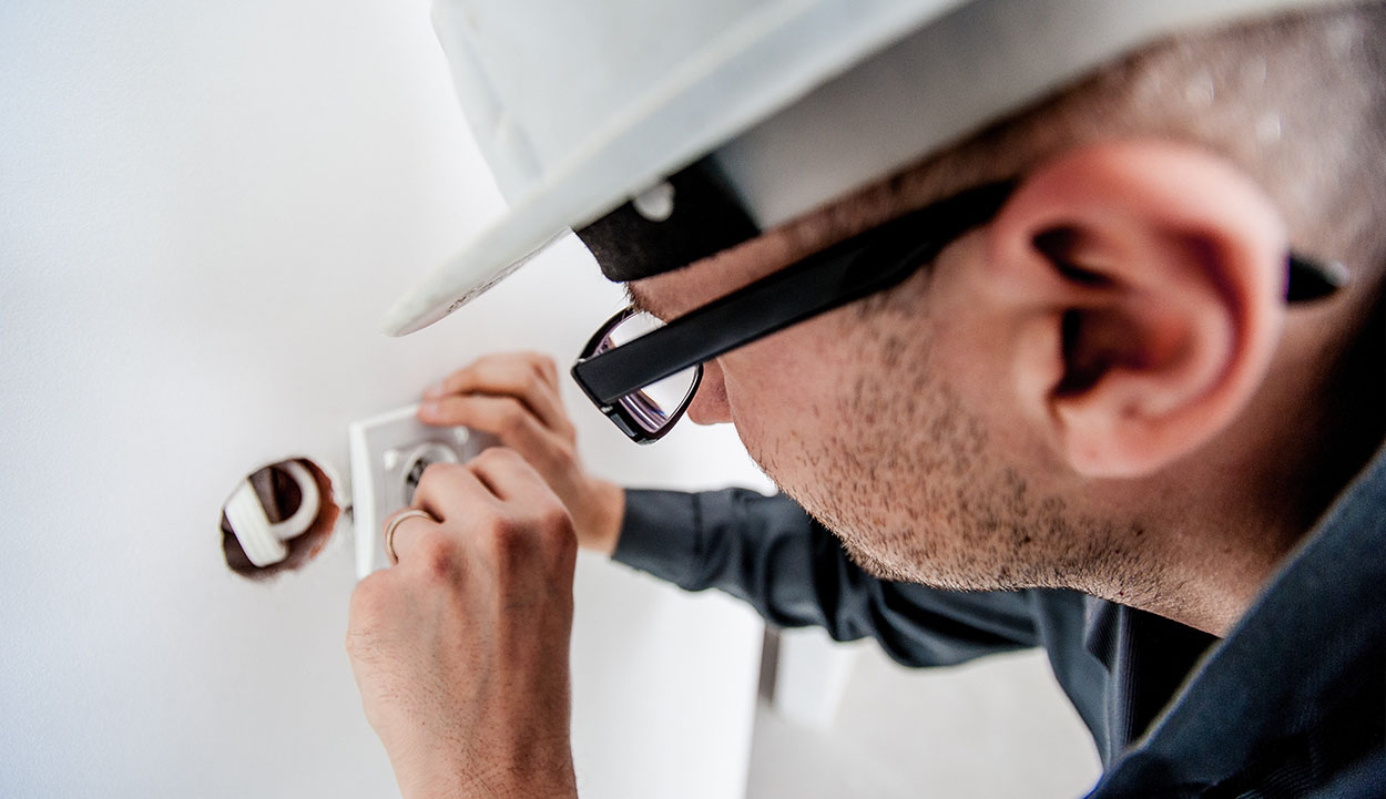 Electrician changing a power socket
